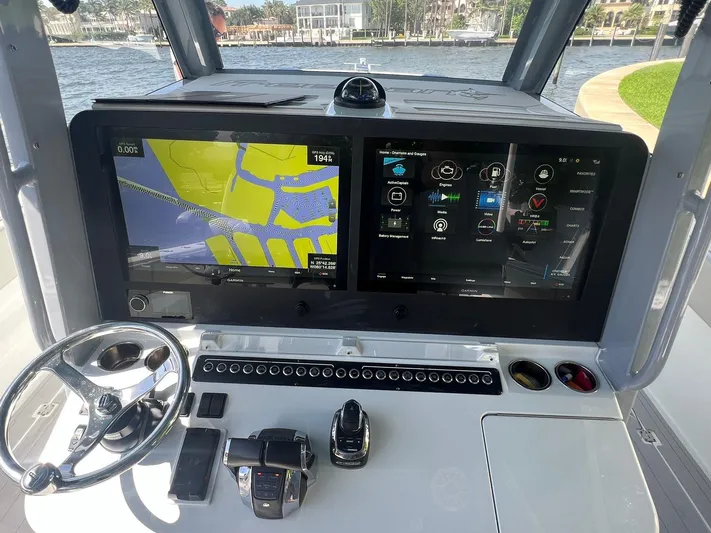 Nomad Yacht Photos Pics Freeman 42 LR 2021 boat dashboard with dual Garmin displays and steering wheel.