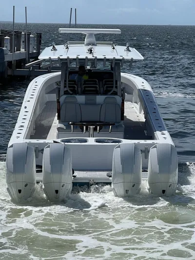 Nomad Yacht Photos Pics 2021 Freeman 42 LR boat with four engines on the water, rear view.