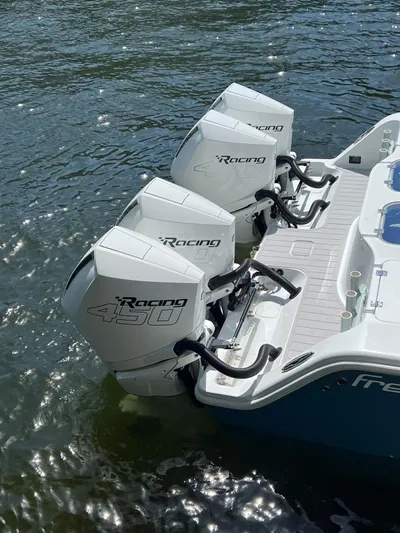 Nomad Yacht Photos Pics Freeman 42 LR 2021 boat with triple Racing 450 outboard engines on water.