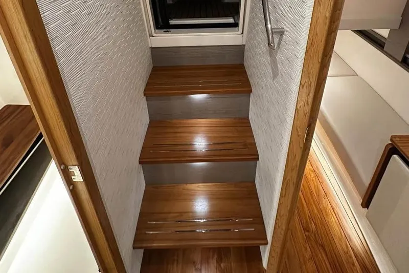 Motivated!! Only 113 Hours Yacht Photos Pics 2023 Tiara Yachts 43 LE interior with wooden stairs and modern design.