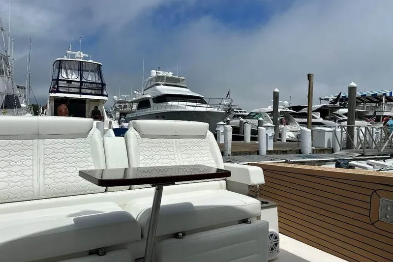 Motivated!! Only 113 Hours Yacht Photos Pics 2023 Tiara Yachts 43 LE at marina, featuring luxurious white seating and wooden accents.