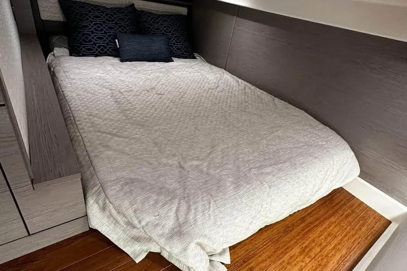 Motivated!! Only 113 Hours Yacht Photos Pics 2023 Tiara Yachts 43 LE cabin interior with cozy bed and stylish pillows.