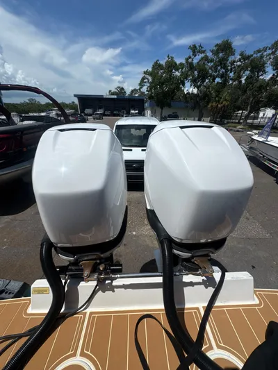 Gabrielle Yacht Photos Pics Twin outboard motors on a 2006 Jupiter 31 CC FWD boat, parked outdoors.
