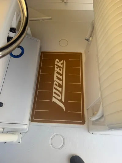 Gabrielle Yacht Photos Pics Interior of 2006 Jupiter 31 CC FWD Seating boat with branded floor mat.