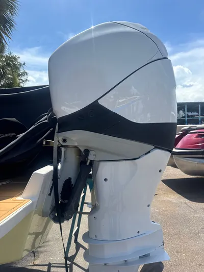 Gabrielle Yacht Photos Pics White outboard motor on a 2006 Jupiter 31 CC FWD boat, sunny day background.