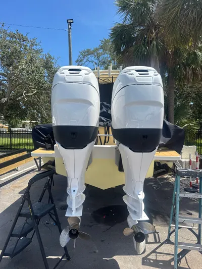 Gabrielle Yacht Photos Pics 2006 Jupiter 31 CC boat with dual outboard motors, parked outdoors.