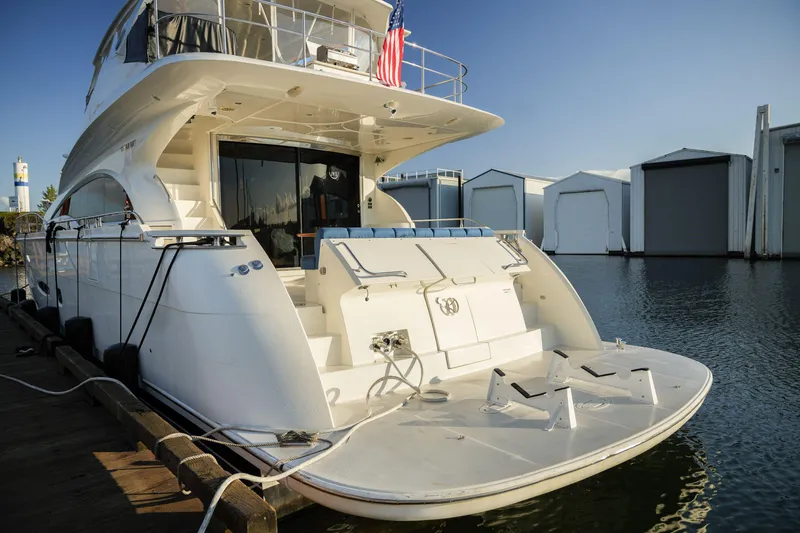  Yacht Photos Pics Luxury 2006 Marquis 65 yacht docked at marina, rear view with clear sky.
