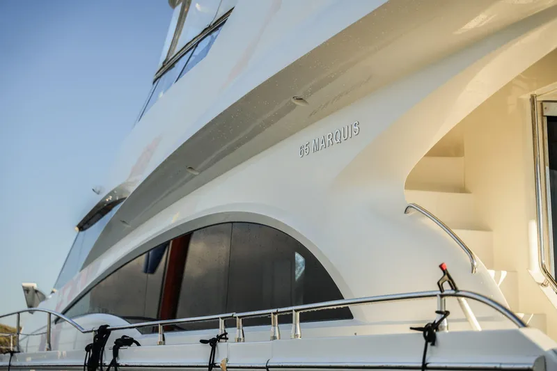  Yacht Photos Pics Luxury 2006 Marquis 65 yacht exterior with sleek design and elegant curves.