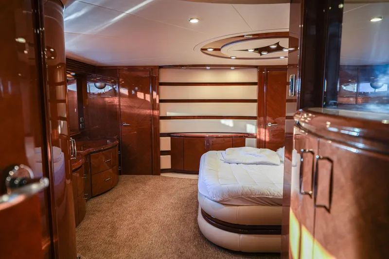  Yacht Photos Pics Luxurious 2006 Marquis 65 yacht interior with elegant wood finishes and cozy bedroom.