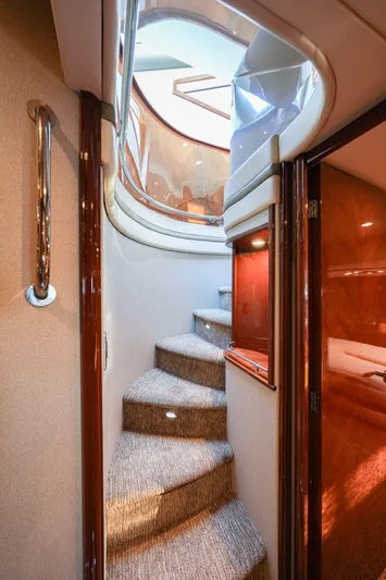  Yacht Photos Pics Interior staircase of 2006 Marquis 65 yacht with elegant design and lighting.