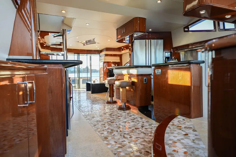  Yacht Photos Pics Luxurious interior of a 2006 Marquis 65 yacht with elegant wood finishes and modern amenities.