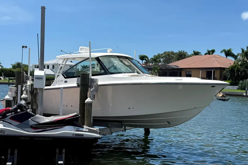  Yacht Photos Pics 2016 Pursuit DC 325 Dual Console boat docked near waterfront homes.