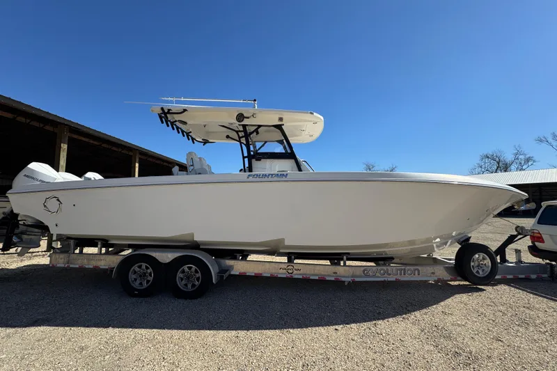  Yacht Photos Pics 2019 Fountain 34 Center Console boat on trailer under clear blue sky.