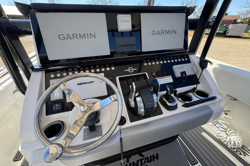  Yacht Photos Pics 2019 Fountain 34 Center Console boat dashboard with Garmin displays and Mercury steering wheel.