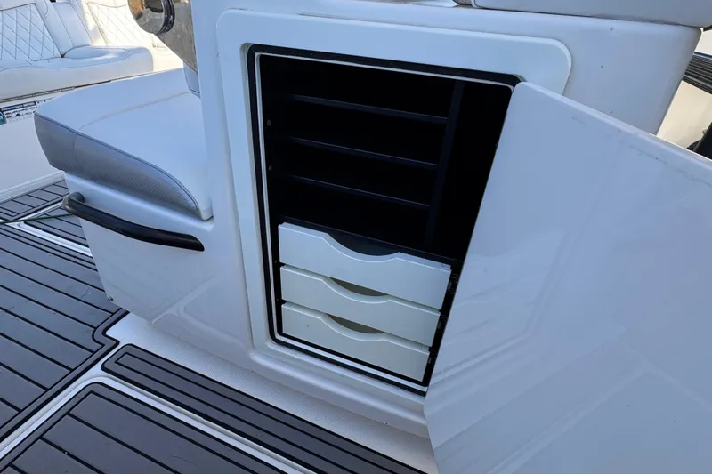  Yacht Photos Pics 2019 Fountain 34 Center Console boat storage compartment with open drawers and seating.