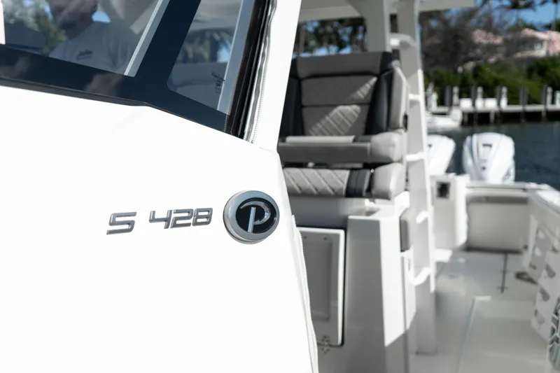 Nomad Yacht Photos Pics 2022 Pursuit S 428 Sport boat, featuring sleek design and comfortable seating.