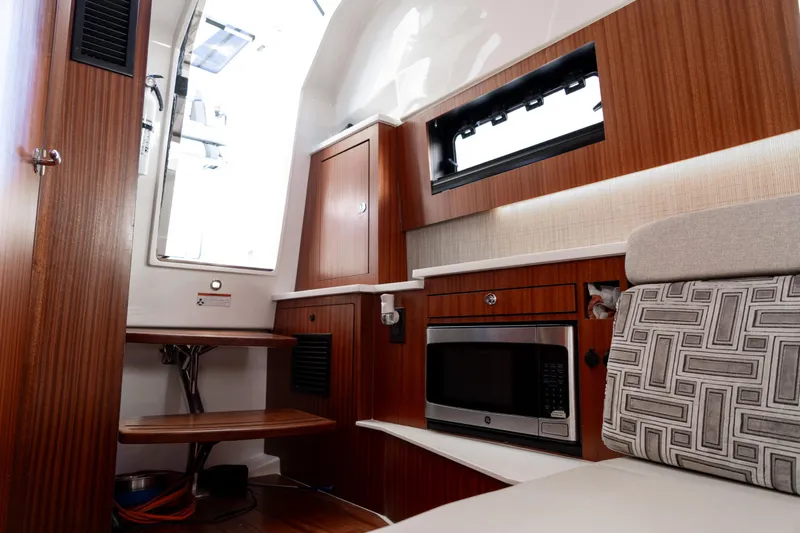 Nomad Yacht Photos Pics Interior of 2022 Pursuit S 428 Sport boat with wood cabinetry and modern amenities.