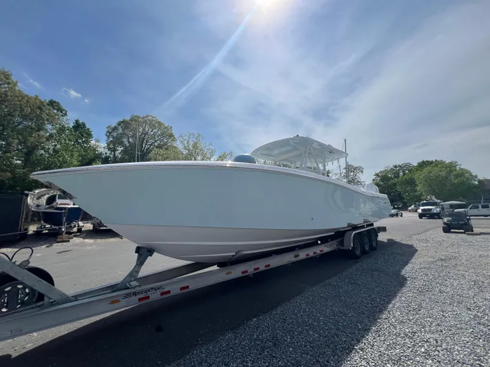 Dealer Demo Yacht Photos Pics 2024 Invincible 39 Open Fisherman boat on a trailer in a parking lot.