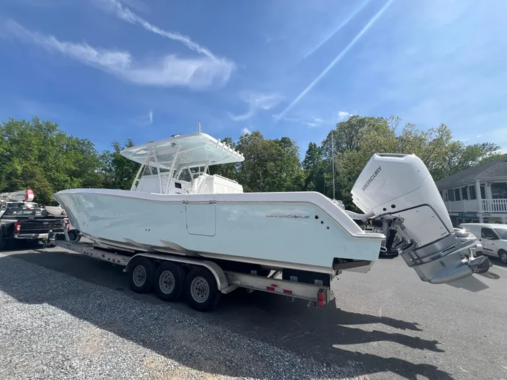 Dealer Demo Yacht Photos Pics 2024 Invincible 39 Open Fisherman boat on a trailer under a clear blue sky.
