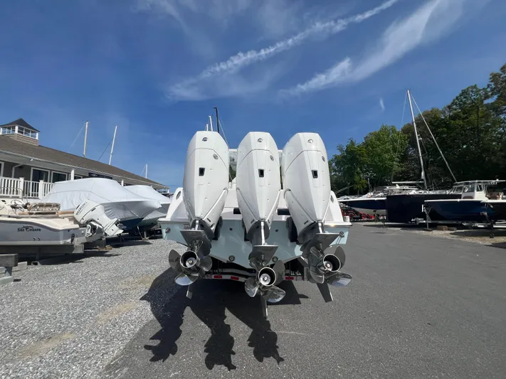 Dealer Demo Yacht Photos Pics 2024 Invincible 39 Open Fisherman with triple outboard engines in a boatyard.