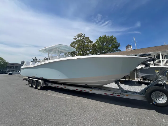 Dealer Demo Yacht Photos Pics 2024 Invincible 39 Open Fisherman boat on a trailer in a parking lot.