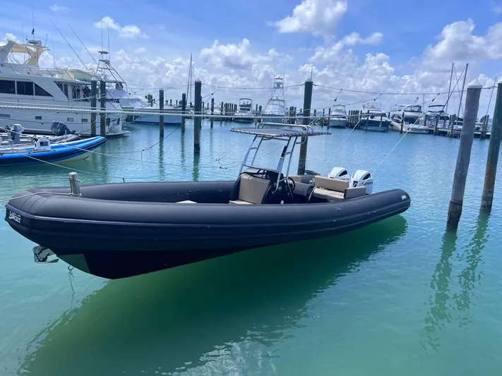  Yacht Photos Pics 2023 Sea Water PHANTOM 280 boat docked in a marina under a clear blue sky.