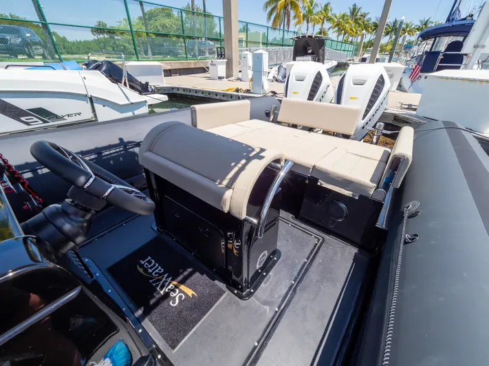  Yacht Photos Pics 2023 Sea Water PHANTOM 280 boat interior with seating and steering wheel at a marina.