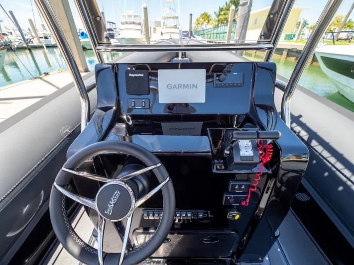  Yacht Photos Pics Cockpit of 2023 Sea Water PHANTOM 280 with Garmin navigation system and sleek steering wheel.