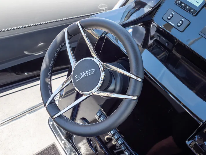 Yacht Photos Pics Steering wheel of 2023 Sea Water PHANTOM 280 boat, featuring sleek design and modern controls.