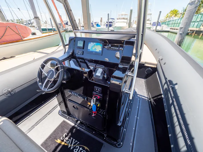  Yacht Photos Pics 2023 Sea Water PHANTOM 280 boat cockpit with steering wheel and navigation system.