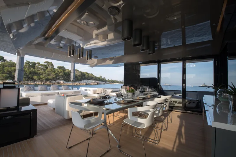 Marcello Yacht Photos Pics Luxurious interior of 2015 Arcadia Yachts Arcadia 85, featuring elegant dining area with ocean view.