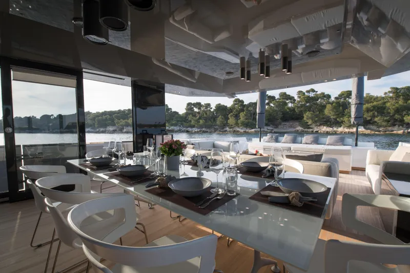 Marcello Yacht Photos Pics Luxurious dining area on 2015 Arcadia Yachts Arcadia 85, featuring elegant tableware and scenic views.