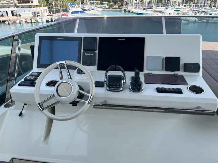  Yacht Photos Pics Helm of 2017 Prestige 680 yacht with modern navigation equipment and steering wheel.