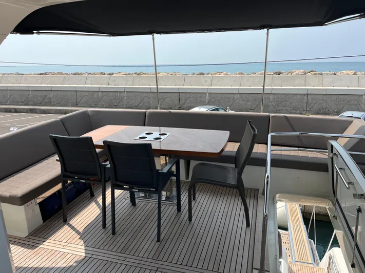  Yacht Photos Pics Prestige 680 yacht deck with seating and table, overlooking the sea, 2017 model.