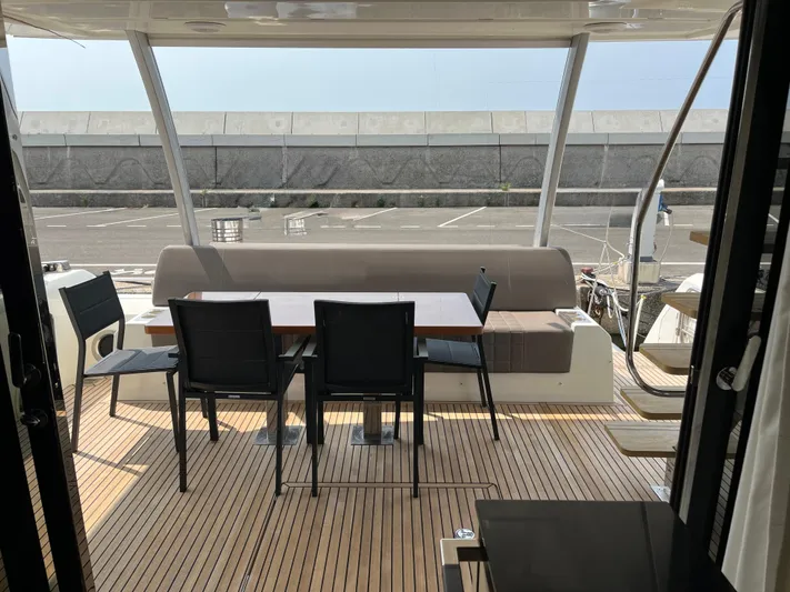  Yacht Photos Pics Outdoor seating area on a 2017 Prestige 680 yacht with wooden deck and modern furniture.