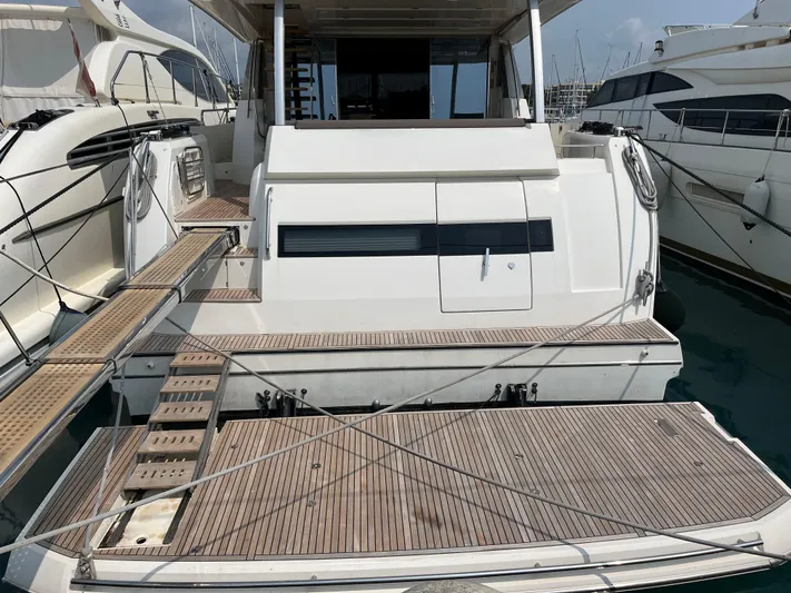  Yacht Photos Pics Luxury yacht Prestige 680, 2017 model, docked with wooden deck and gangway.