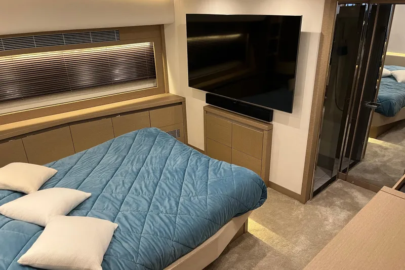  Yacht Photos Pics Luxurious bedroom in 2017 Prestige 680 yacht with blue bedding and large TV.