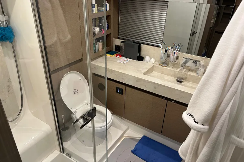  Yacht Photos Pics Luxurious bathroom in a 2017 Prestige 680 yacht with modern amenities and elegant design.