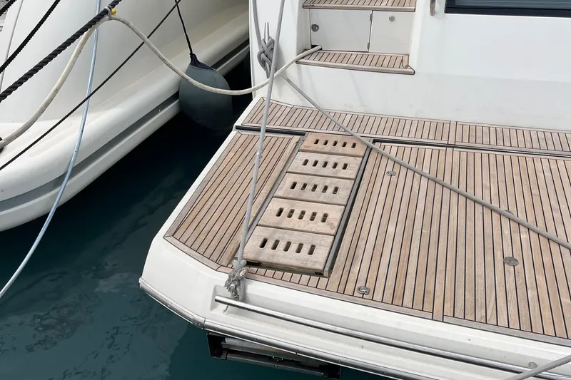  Yacht Photos Pics Teak deck of a 2017 Prestige 680 yacht, docked with mooring lines.