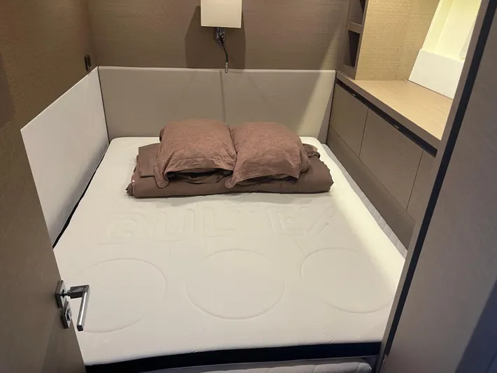  Yacht Photos Pics Luxurious bedroom interior in a 2017 Prestige 680 yacht, featuring a cozy bed and modern design.