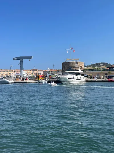  Yacht Photos Pics Luxury yacht Prestige 680, 2017 model, docked in a scenic marina under a clear blue sky.