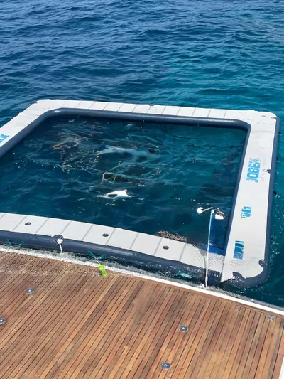  Yacht Photos Pics Floating pool attached to a Prestige 680 yacht, 2017, in clear blue ocean water.