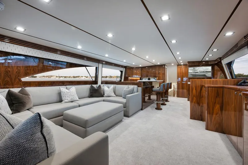  Yacht Photos Pics Luxurious interior of 2019 Viking 80 Convertible yacht with elegant seating and wood finishes.
