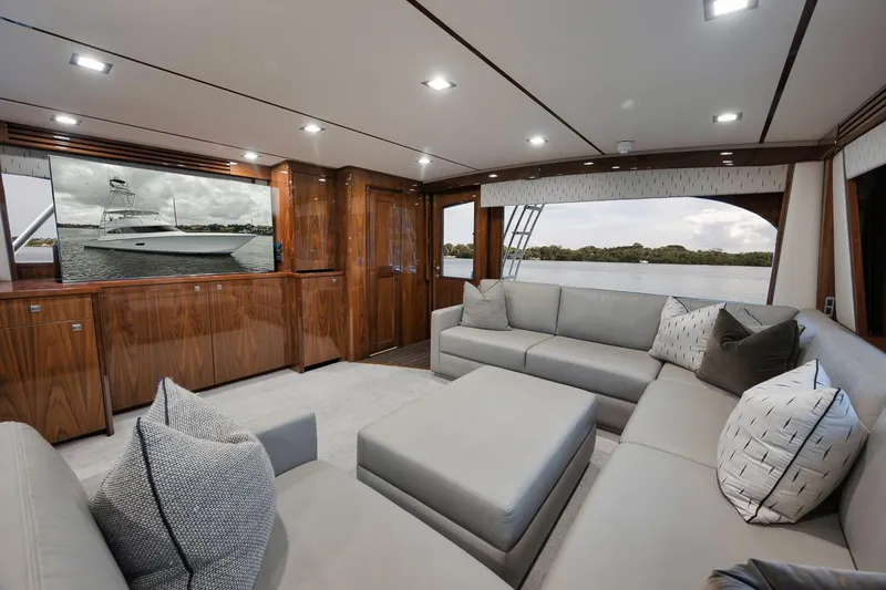  Yacht Photos Pics Luxurious interior of 2019 Viking 80 Convertible yacht with plush seating and elegant wood finishes.