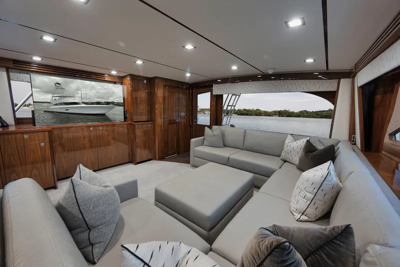  Yacht Photos Pics Luxurious interior of 2019 Viking 80 Convertible yacht with plush seating and elegant wood finishes.
