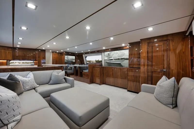  Yacht Photos Pics Luxurious interior of 2019 Viking 80 Convertible yacht with elegant wood finishes and plush seating.