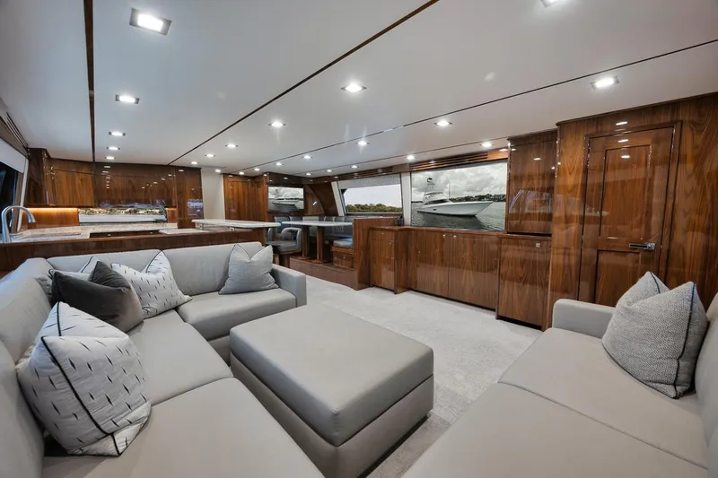  Yacht Photos Pics Luxurious interior of 2019 Viking 80 Convertible yacht with modern furnishings and wood finishes.