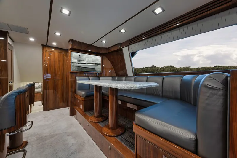 Yacht Photos Pics Luxurious interior of 2019 Viking 80 Convertible yacht with elegant seating and wood finishes.
