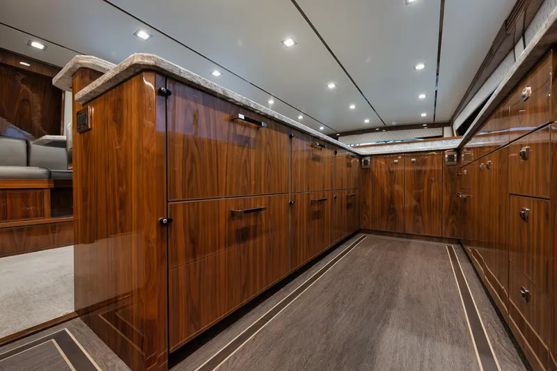 Yacht Photos Pics Luxurious interior of 2019 Viking 80 Convertible yacht with elegant wood cabinetry.