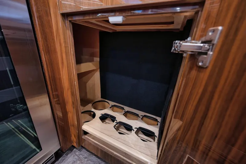  Yacht Photos Pics Wooden cabinet with cup holders in 2019 Viking 80 Convertible yacht interior.